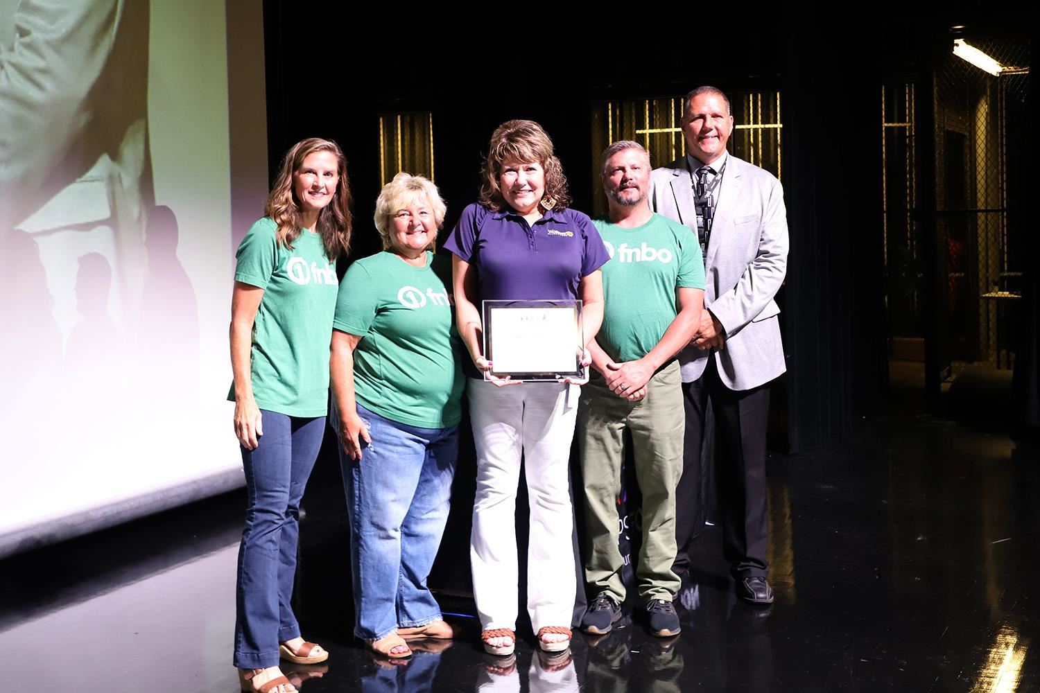 Michelle Thorne accepting her Teacher of the Year Award on stage at GIPS Welcome Back.